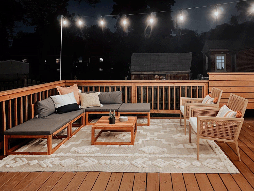 Terrace with lights hanging above seating area